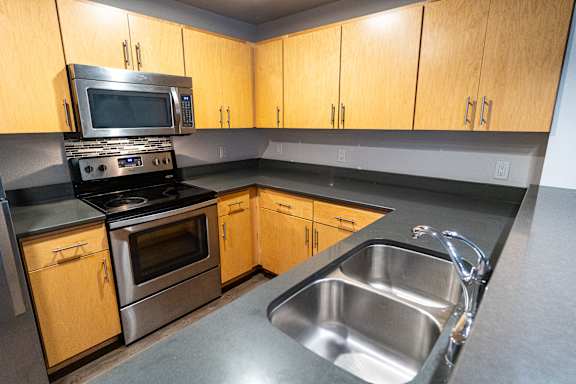 A kitchen with wooden cabinets and stainless steel appliances.