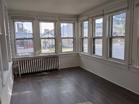A room with a window overlooking a street.