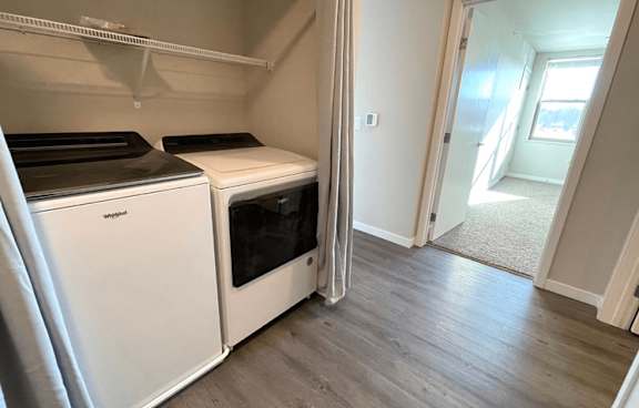 A white dishwasher and oven in a kitchen.