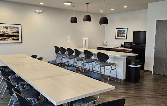 A conference room with a long table and chairs.