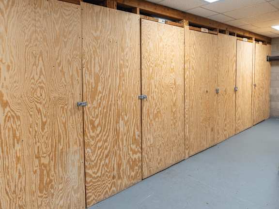 A row of wooden lockers in a room.