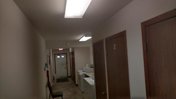 A hallway with a door numbered 2 at the end.