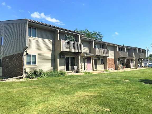 Apartment complex with a green lawn in front.