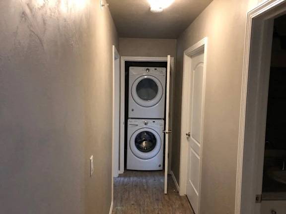 A white washer and dryer in a narrow hallway.