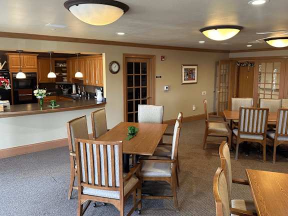 A dining room with a table set for six.