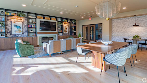 A modern dining room with a wooden table and chairs.