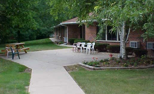 A house with a patio and a tree.