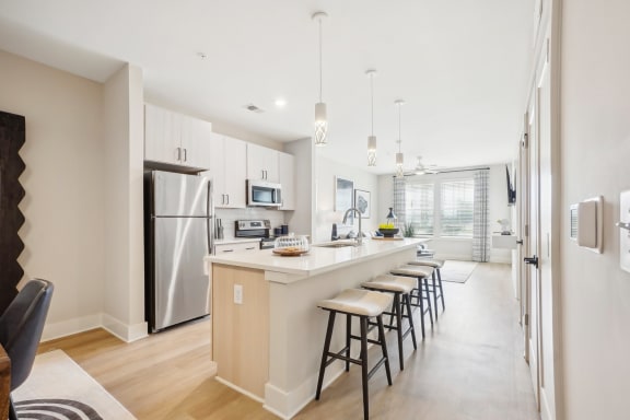 a kitchen with a long island with bar stools