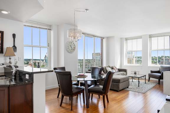 A modern kitchen with a dining table and chairs.