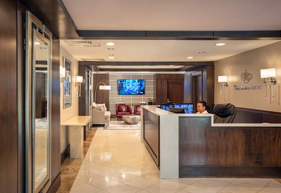 A reception area with a woman sitting behind the desk.