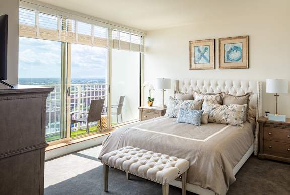 A bedroom with a large bed and a view of the ocean.