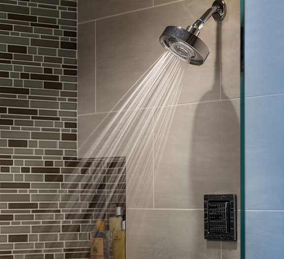 A shower head with water flowing from it.
