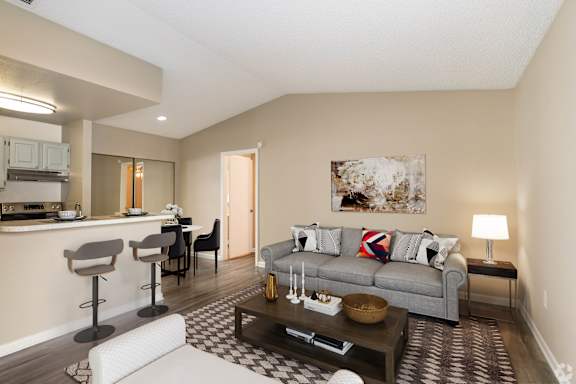 A living room with a grey couch and a coffee table.