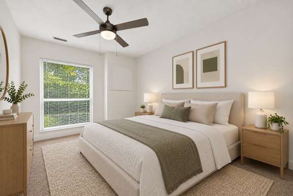 A bedroom with a bed, nightstands, and a ceiling fan.
