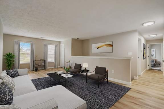 A living room with a grey sofa, a black coffee table, and a painting on the wall.