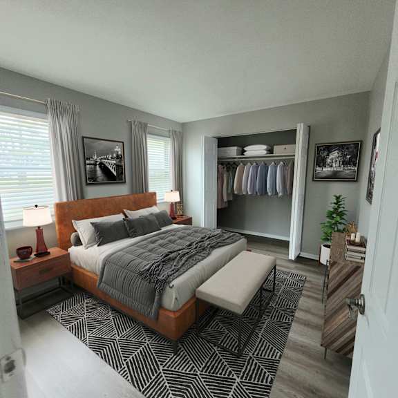 A bedroom with a large bed and a bench in front of it.