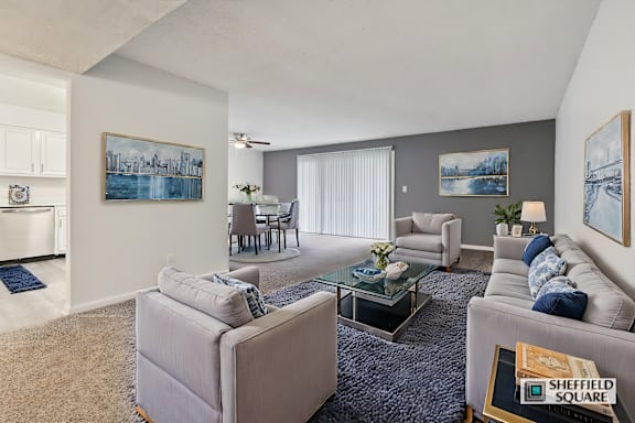 A living room with a grey couch and a coffee table.
