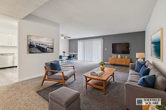 A living room with a sofa, chairs, and a coffee table.