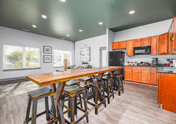 A kitchen with a bar area and wooden floors.