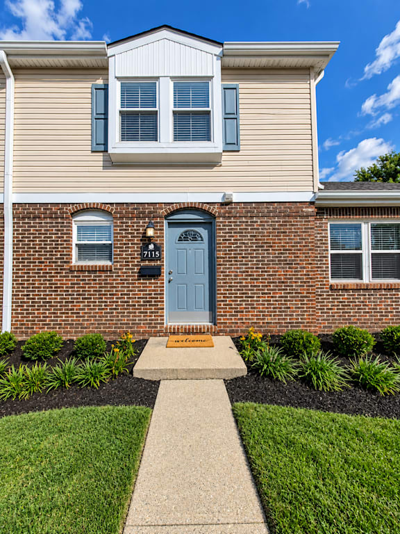 A house with a blue door and a sign that says "1175" on it.