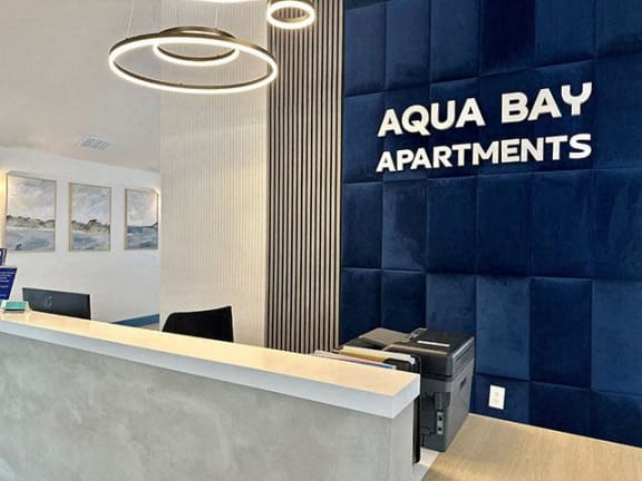 Lobby with a reception desk at Aqua Bay Apartments in Naples, FL 34116