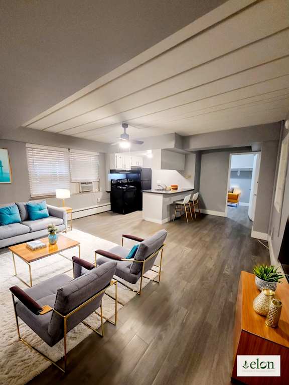 A living room with a grey couch, a coffee table, and a wooden floor.