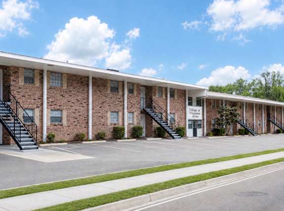 A brick building with the words "Village at Virginia" on the front.
