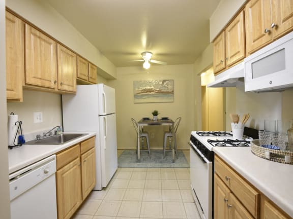 Eat in kitchens equipped with washer and dryer at Deer Park Apartments