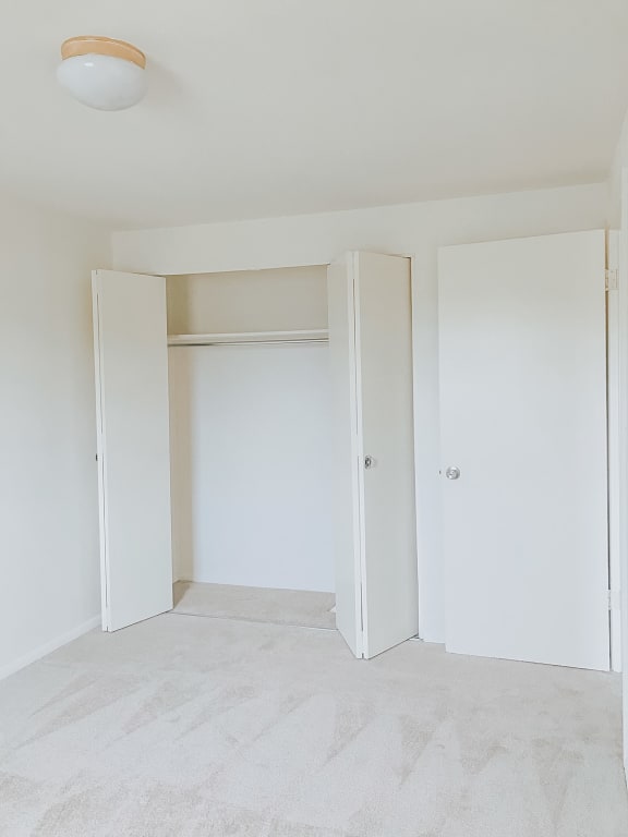 A bedroom with white walls and white carpet at Hyde Park Apartments*, Essex, MD