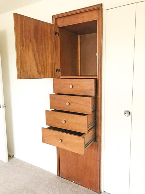 Narrow cabinet with drawers on the side of a door at Hyde Park Apartments*, Maryland, 21221