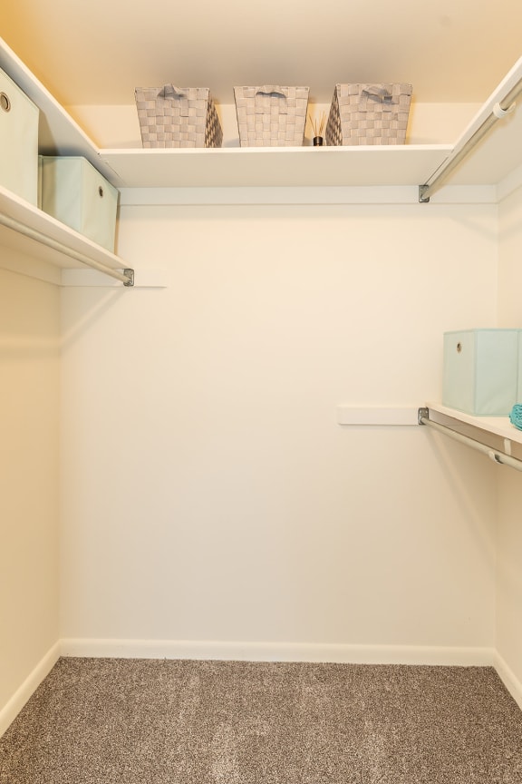 a walk in closet with white walls and shelves at Chapel Valley Townhomes, Baltimore