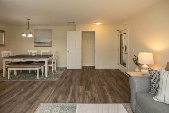 A living room with a grey couch and a wooden floor.