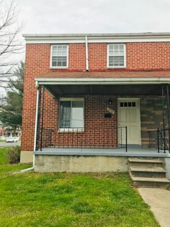 Brick house with a porch and a white door at Hyde Park Apartments*, Essex