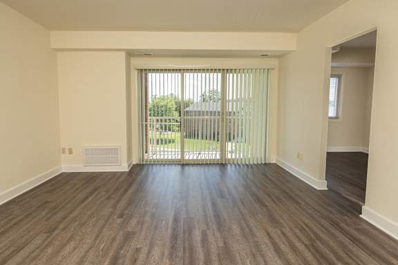 A room with wooden flooring and a sliding glass door at Lawyers Hill Apartments, Elkridge, MD, 21075