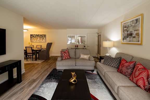 A living room with a grey couch and a black coffee table at Ivy Hall Apartments*, Maryland, 21204