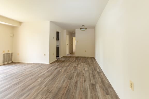 a bedroom with hardwood floors and white walls at Seminary Roundtop Apartments, Lutherville