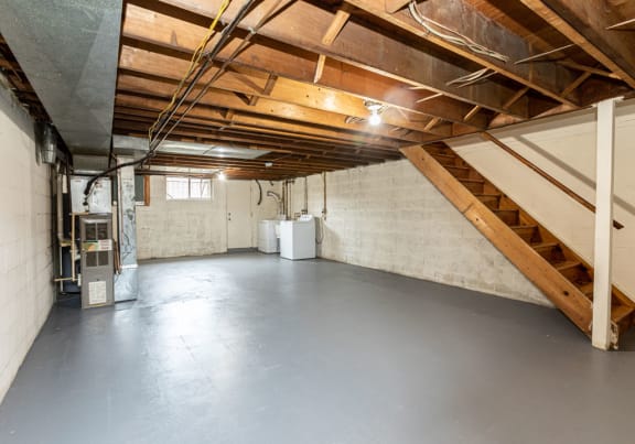 Basement with a washer and dryer at Foxridge Townhomes, Baltimore, 21221