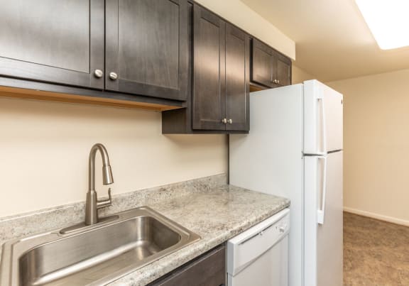 Kitchen with a sink refrigerator and dishwasher at Foxridge Townhomes, Baltimore Maryland