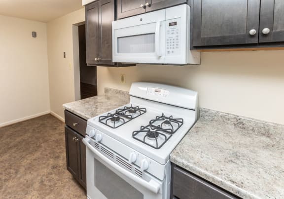 Kitchen with a stove and microwave at Foxridge Townhomes, Baltimore Maryland