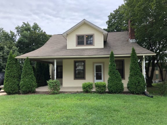 a home with a gray roof and a green lawn at Ivy Hall Apartments*, Maryland