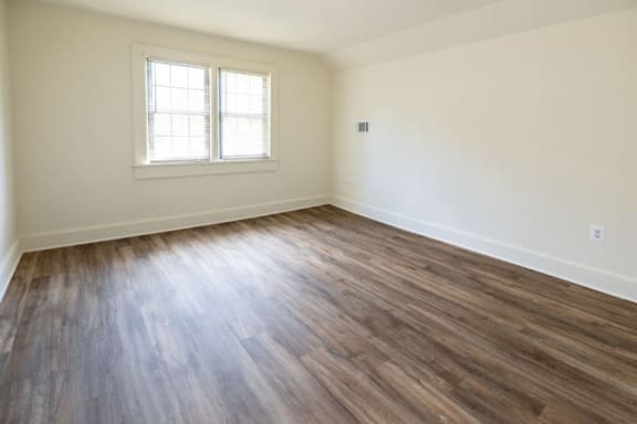 a bedroom with hardwood flooring at the oxford at estonia apartments in san an at Ivy Hall Apartments*, Towson Maryland