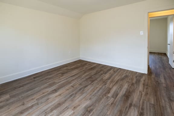 a bedroom with hardwood flooring at the whispering winds apartments in pearland, tx at Ivy Hall Apartments*, Towson Maryland