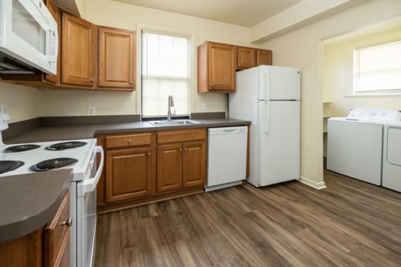 a kitchen with wooden cabinets and white appliances at Ivy Hall Apartments*, Maryland, 21204