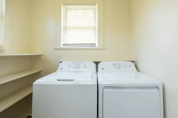 a washer and dryer in a room with a window at Ivy Hall Apartments*, Towson, MD