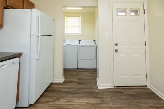 a kitchen with a refrigerator and a washer and dryer at Ivy Hall Apartments*, Maryland