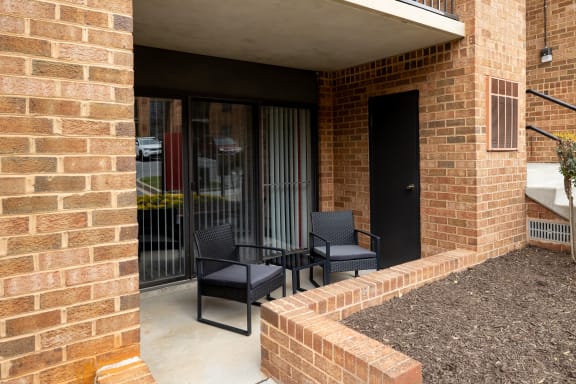 Patio with two chairs and a table at Ivy Hall Apartments*, Maryland, 21204