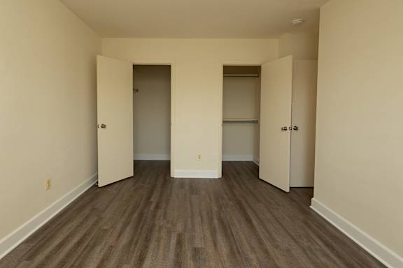 A room with wood flooring and three doors at Lawyers Hill Apartments, Elkridge, MD, 21075