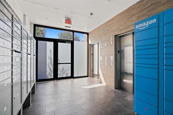 A hallway with a blue Amazon locker on the right.