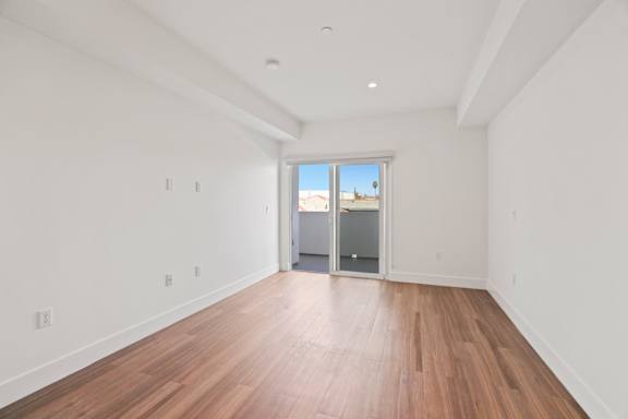 A room with wooden floors and white walls.