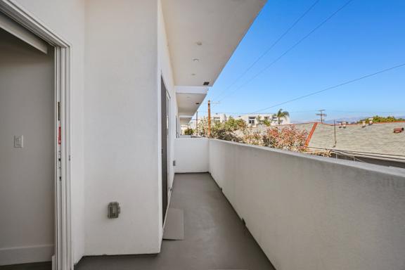A balcony with a view of the desert outside.
